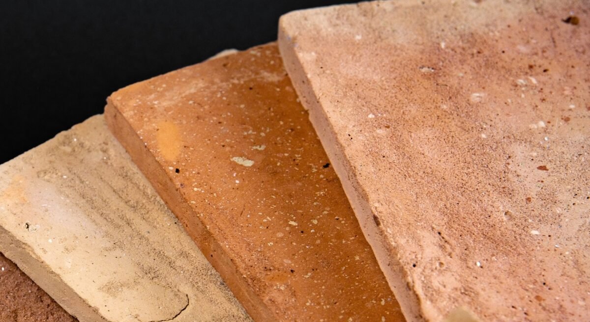 Everything About Terracotta Tiles for Outdoor Spaces Close-up of handcrafted terracotta tiles with natural color shading.