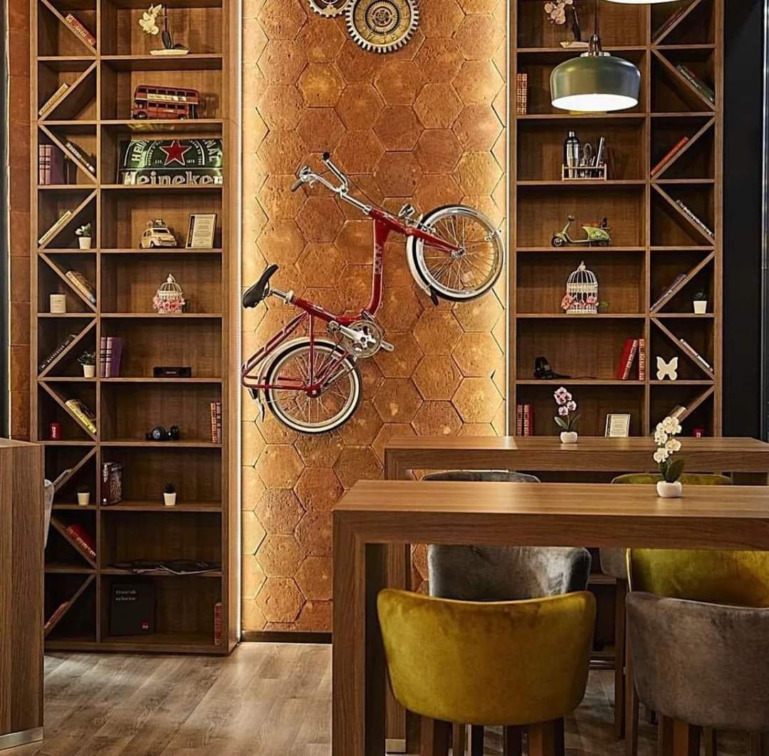 Handgefertigte traditionelle Terracotta Fliesen im Hexagon-Format als Wandverkleidung im Innenraum mit Holzregalen und Vintage-Fahrrad